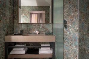 a bathroom with a sink and a mirror at Casa Guttmann in Rome +120 photos