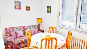 a living room with a table and chairs and a couch at Home Sweet Home No1 in Belgrade