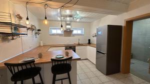 a kitchen with a refrigerator and a table and chairs at Stay & Relax in Großostheim