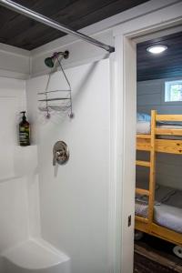 a bathroom with a shower and a bunk bed at Cricket by the Creek - Creek, Gym, Trails, Kayaks in Menlo