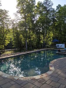 a swimming pool in a yard with trees at Cricket by the Creek - Creek, Gym, Trails, Kayaks in Menlo