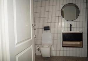 a bathroom with a toilet and a tv on the wall at Kénōsis Guestfarm - Room 1 in Springbok +12 photos