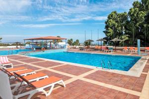 a large swimming pool with chairs and a gazebo at White Studio and Terrace in Albufeira