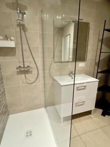 a bathroom with a shower and a sink at La Rive, bord de Saône 