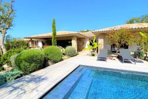 a house with a swimming pool in front of a house at Villa Pignotulli Di Cirendinu in Sainte-Lucie de Porto-Vecchio