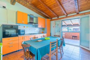 a kitchen with a table and some orange cabinets at Casa Pina a due passi dal mare in Augusta