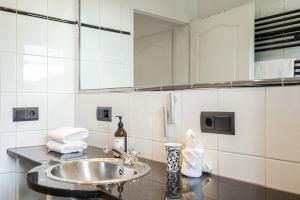 a bathroom with a sink and a mirror at Meer in Süderende +27 photos
