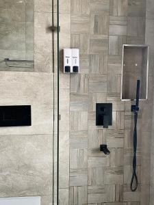 a bathroom with a shower with a glass door at Ex Daya Residency in Dar es Salaam +20 photos