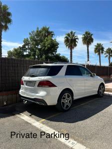a white car parked in a parking lot at Beach Front 2 Bedrooms Apartment in Torredembarra