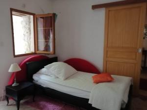a small bedroom with a bed and a window at Gîte Madrelle in Lussault-sur-Loire