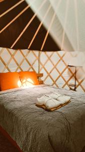 a bedroom with a bed in a tent at Yurt Birzs with Sauna at Kleja Camping in Eikaži