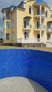 a large building with a blue object in front of it at Villa eleqant in Tbilisi City