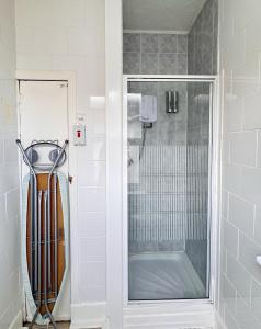 a shower with a glass door in a bathroom at Kendal Hotel in Blackpool