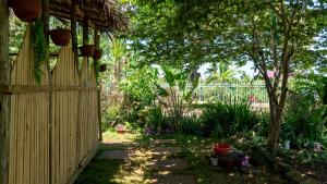 a garden with a fence and a tree at Shoraju Estate in Mchamba Wima