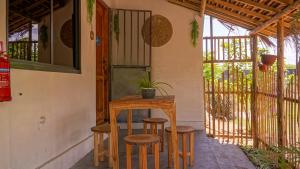 a table and stools with a plant on a patio at Shoraju Estate in Mchamba Wima