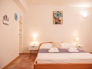 a bedroom with a large bed with two night stands at Apartman Jakša in Hvar