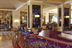 a lobby of a hotel with chairs and tables at Villa Rosa Kempinski in Nairobi