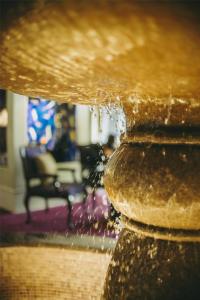 a close up of a water fountain in a living room at Villa Rosa Kempinski in Nairobi
