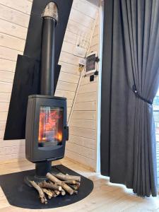 a wood stove with a fire in a room at Diamond chalet in Ogrody +30 photos
