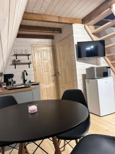 a kitchen with a table and chairs in a room at Diamond chalet in Ogrody