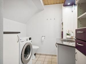 a white laundry room with a washer and dryer at Holiday Home Gunhilde - 6km from the sea by Interhome in Glesborg +10 photos