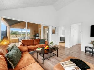 a living room with a couch and a table at Holiday Home Dreng - 300m from the sea by Interhome in Harboør