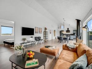 a living room with a couch and a table at Holiday Home Dreng - 300m from the sea by Interhome in Harboør