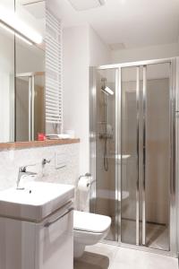 a bathroom with a toilet and a sink and a shower at Wolska Residence in Warsaw +41 photos