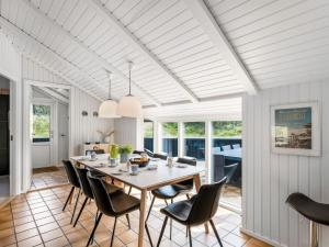 a dining room with a table and chairs at Holiday Home Emin - 700m from the sea by Interhome in Vejers Strand