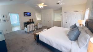 a bedroom with a white bed with blue pillows at Tranquil Turquoise Retreat home in South Padre Island +138 photos