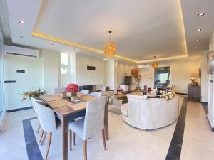 a dining room and living room with a table and chairs at Luxury Villa w Private Pool Panoramic View in Bogazici