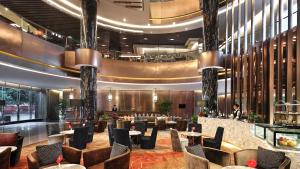a lobby of a hotel with tables and chairs at Crowne Plaza Kunming City Centre by IHG in Kunming