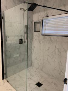 a shower with a glass door in a bathroom at Ocean view 1 bedroom, 1 bathroom in Port Antonio
