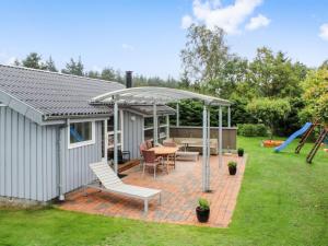 a patio with a gazebo and a table and chairs at Holiday Home Albertina - 200m from the sea by Interhome in Hals