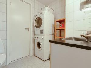 a kitchen with a washing machine and a sink at Holiday Home Albertina - 200m from the sea by Interhome in Hals +14 photos