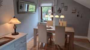 a dining room with a table with chairs and a lamp at ChristRose in Trechtingshausen