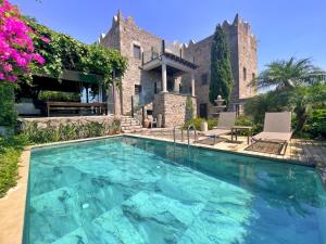 a swimming pool in front of a house at Private Pool Getaway in a Luxury Stone Villa in Bodrum City