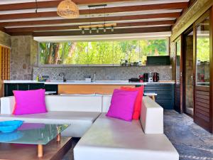 a living room with a white couch and pink pillows at Private Pool Getaway in a Luxury Stone Villa in Bodrum City