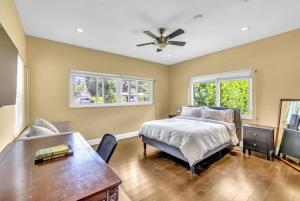 a bedroom with a bed and a ceiling fan at 4BR Jacuzzi, Heated Pool and Full-Size Ball Courts in Pompano Beach +22 photos