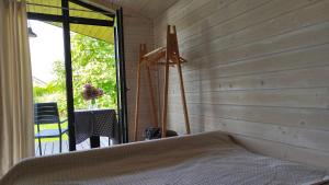 a bedroom with a bed and a large window at Olly House in Glebovka +26 photos