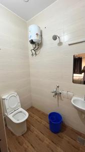 a bathroom with a toilet and a sink at Greenapple Residency in Chennai