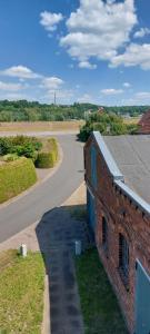an aerial view of a road next to a brick building at Deichblick in Tespe