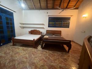 a bedroom with two beds and a ceiling at Rella Dream in Matara