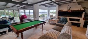 a living room with a pool table in it at OUPAs se Plek in Kontiki