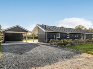 a house with a garage and a driveway at Holiday Home Geri - 700m from the sea by Interhome in Hals
