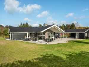 a house with a black roof and a yard at Holiday Home Geri - 700m from the sea by Interhome in Hals +28 photos