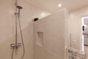 a bathroom with a shower with a glass door at Joli T2 Au Coeur Des Rues Piétonnes in Sanary-sur-Mer +12 photos