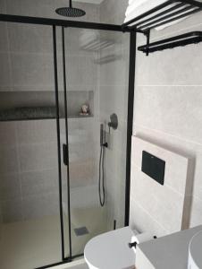 a bathroom with a shower with a toilet and a sink at WOWOLIDAYS Suite Love Ronda in Ronda