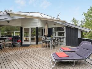 a deck with chairs and a table on a house at Holiday Home Selver - 250m from the sea by Interhome in Hals