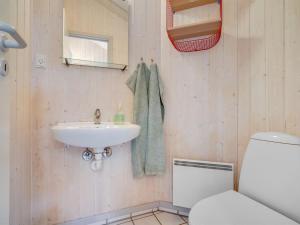 a bathroom with a sink and a toilet at Holiday Home Selver - 250m from the sea by Interhome in Hals